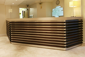 University Reception - grooved-wooden-reception-desk