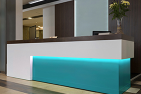 University Reception - teal-underlit-reception-desk